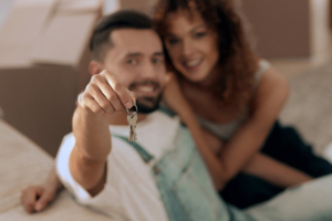 Couple holding up new house keys